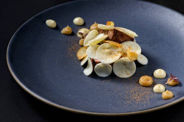 fine dining of 60 days grass beef with parsnip, wood year, charred onion